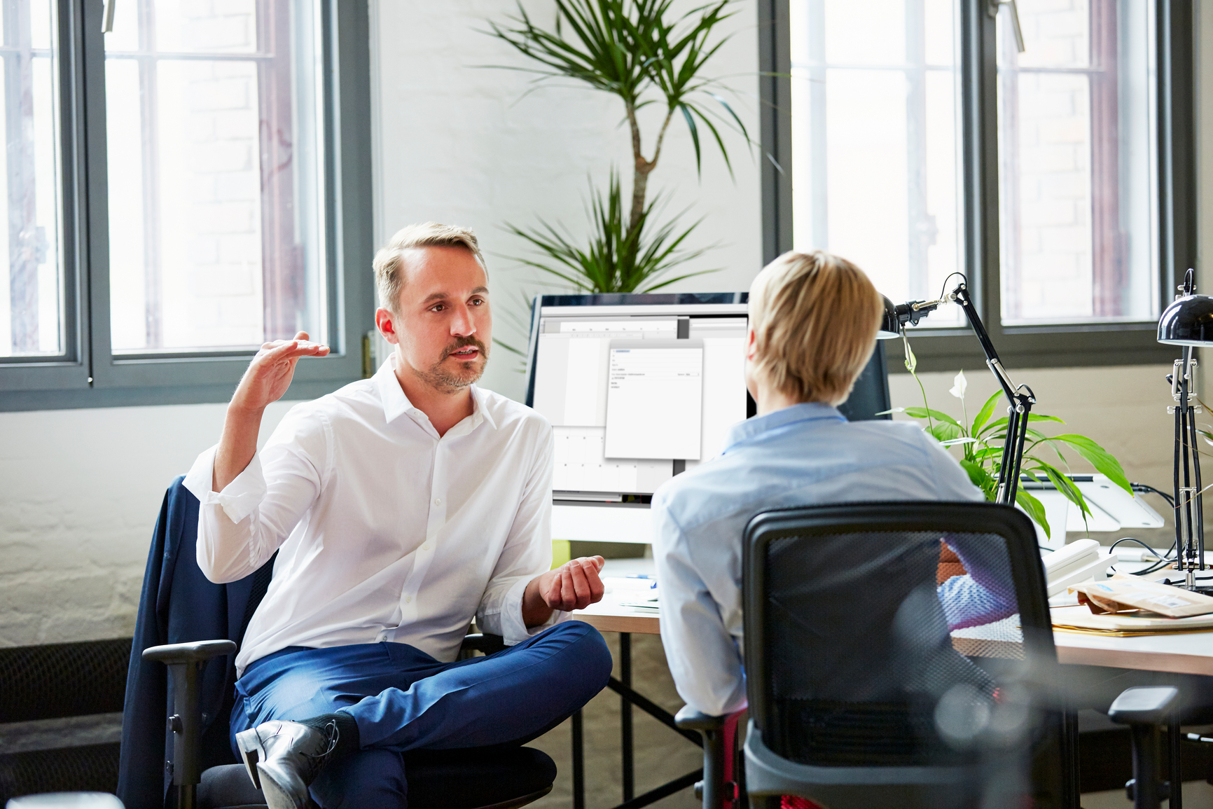 Businessman Discussing With Colleague In Office